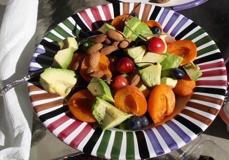 Scepter Breakfast of a whole avocado, apricots, blueberries, and cherries topped with almonds that are organic and sprouted