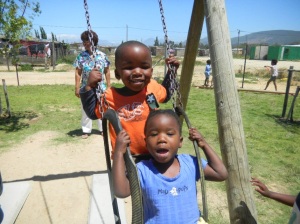 South Africa orphans swinging in playground of orphange for HIV victims.